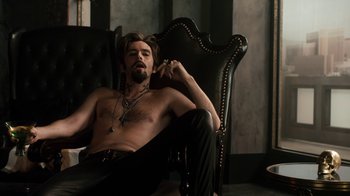 Movie still from “Fright Night” (2011), directed by Craig Gillespie – A man sitting in a chair with his hand on his chin; Medium shot, High angle