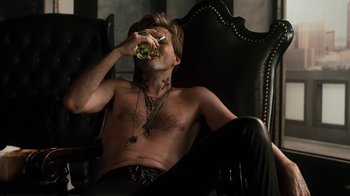Movie still from “Fright Night” (2011), directed by Craig Gillespie – A man sitting in a chair with his mouth open; Medium shot, Overhead angle
