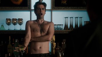 Movie still from “Fright Night” (2011), directed by Craig Gillespie – A shirtless man holding a knife in a kitchen; Medium shot, Over the shoulder angle
