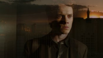 Movie still from “Fright Night” (2011), directed by Craig Gillespie – A man is looking out of a window at dusk; Close Up shot, Low angle