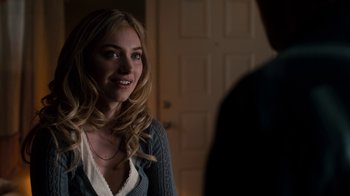 Movie still from “Fright Night” (2011), directed by Craig Gillespie – A young woman smiles as she looks at a man; Close Up shot, Over the shoulder angle