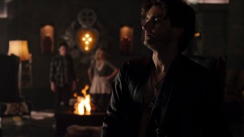 Movie still from “Fright Night” (2011), directed by Craig Gillespie – A man standing in front of a fire pit with other people; Medium shot, Over the shoulder angle