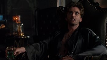 Movie still from “Fright Night” (2011), directed by Craig Gillespie – A man sitting in a chair wearing a black robe; Close Up shot, High angle