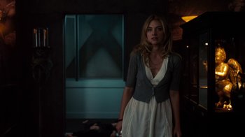 Movie still from “Fright Night” (2011), directed by Craig Gillespie – A beautiful young lady standing in a dark room; Medium shot, Over the shoulder angle
