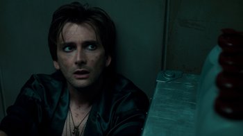 Movie still from “Fright Night” (2011), directed by Craig Gillespie – A person sitting in front of a table; Close Up shot, Overhead angle