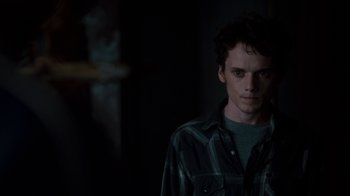 Movie still from “Fright Night” (2011), directed by Craig Gillespie – A young man in a dark room looking at the camera; Close Up shot, Over the shoulder angle