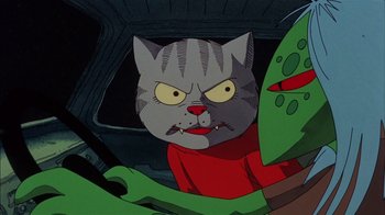 Movie still from “Fritz the Cat” (1972), directed by Ralph Bakshi – A cartoon of a gray cat with a red shirt on; Close Up shot, Low angle