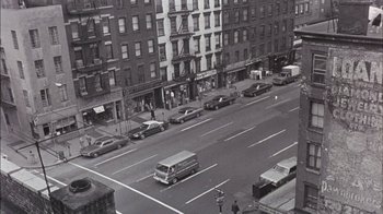 Movie still from “Fritz the Cat” (1972), directed by Ralph Bakshi – An aerial view of an intersection in a city; Extreme Wide shot, High angle