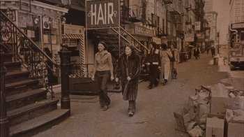 Movie still from “Fritz the Cat” (1972), directed by Ralph Bakshi – A group of people walking down a street; Wide shot, High angle