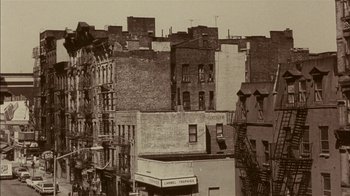 Movie still from “Fritz the Cat” (1972), directed by Ralph Bakshi – A black and white photo of some buildings in a city; Extreme Wide shot, High angle