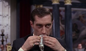 Movie still from “From Russia with Love” (1963), directed by Terence Young – A person holding a piece of food; Close Up shot, High angle