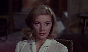 Movie still from “From Russia with Love” (1963), directed by Terence Young – A beautiful woman with blonde hair wearing a white shirt; Close Up shot, Over the shoulder angle