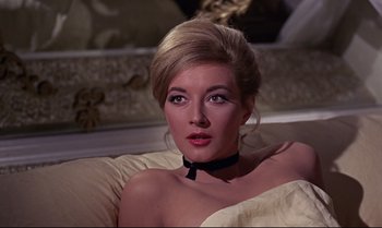 Movie still from “From Russia with Love” (1963), directed by Terence Young – A beautiful woman with blonde hair wearing a white dress; Close Up shot, High angle