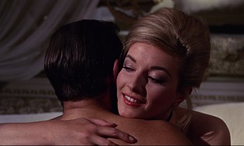Movie still from “From Russia with Love” (1963), directed by Terence Young – A man and a woman hugging in a room; Close Up shot, Low angle