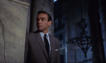 Movie still from “From Russia with Love” (1963), directed by Terence Young – Sean connery as james bond in the movie dr; Medium shot, Low angle