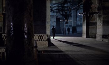 Movie still from “From Russia with Love” (1963), directed by Terence Young – A man walking down a street at night; Extreme Wide shot, High angle