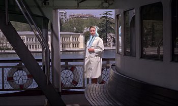 Movie still from “From Russia with Love” (1963), directed by Terence Young – A woman standing on the deck of a boat in the water; Wide shot, Low angle