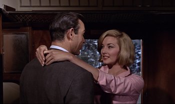 Movie still from “From Russia with Love” (1963), directed by Terence Young – A man and a woman standing next to each other; Medium shot, Over the shoulder angle