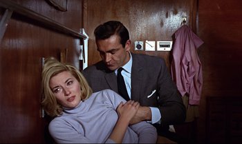 Movie still from “From Russia with Love” (1963), directed by Terence Young – A man and a woman are in a room together; Medium shot, Low angle