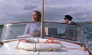 Movie still from “From Russia with Love” (1963), directed by Terence Young – A man and a woman on a boat in the water; Medium shot, Low angle