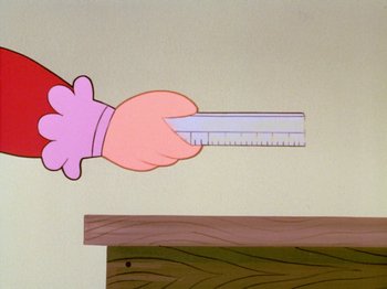 Movie still from “Frosty the Snowman” (1969), directed by Jules Bass – A hand holding a ruler in front of a wall; Extreme Close Up shot, Low angle