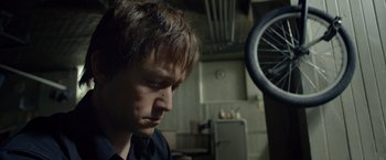 Movie still from “The Walk” (2015), directed by Robert Zemeckis – A man in a black shirt is in a kitchen; Close Up shot, Low angle