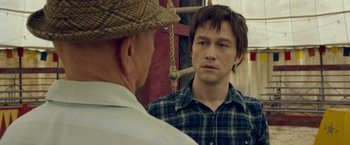 Movie still from “The Walk” (2015), directed by Robert Zemeckis – A man looking at himself in the mirror while standing next to another man; Close Up shot, Over the shoulder angle