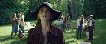 Movie still from “The Walk” (2015), directed by Robert Zemeckis – A young woman wearing a hat in a park; Medium shot, Low angle