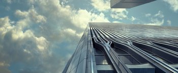 Movie still from “The Walk” (2015), directed by Robert Zemeckis – Looking up at a skyscraper in a cloudy sky; Extreme Wide shot, Low angle