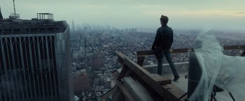 Movie still from “The Walk” (2015), directed by Robert Zemeckis – A man standing on top of a building looking at a city; Wide shot, High angle