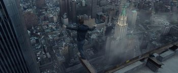 Movie still from “The Walk” (2015), directed by Robert Zemeckis – A man standing on the edge of a ledge above a city; Extreme Wide shot, High angle