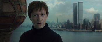 Movie still from “The Walk” (2015), directed by Robert Zemeckis – A man in a black shirt is in front of a city skyline; Close Up shot, Low angle