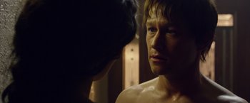 Movie still from “The Walk” (2015), directed by Robert Zemeckis – A young man looking into a mirror while a young woman looks at him; Close Up shot, Over the shoulder angle