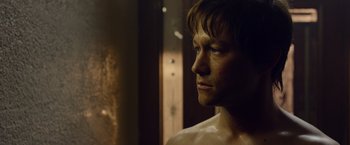 Movie still from “The Walk” (2015), directed by Robert Zemeckis – A person looking at something in a mirror; Close Up shot, Over the shoulder angle