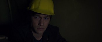 Movie still from “The Walk” (2015), directed by Robert Zemeckis – A man wearing a hard hat in the dark; Close Up shot, High angle