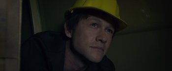 Movie still from “The Walk” (2015), directed by Robert Zemeckis – A person wearing a hard hat; Close Up shot, Overhead angle