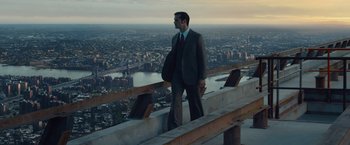 Movie still from “The Walk” (2015), directed by Robert Zemeckis – A man in a suit standing on top of a building; Wide shot, Low angle
