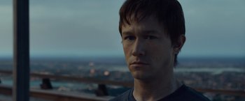 Movie still from “The Walk” (2015), directed by Robert Zemeckis – A person with a city in the background; Close Up shot, Over the shoulder angle