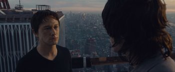 Movie still from “The Walk” (2015), directed by Robert Zemeckis – A man and a woman looking out over a city at night; Close Up shot, Over the shoulder angle