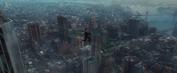 Movie still from “The Walk” (2015), directed by Robert Zemeckis – A man standing on top of a tall building on a wire; Extreme Wide shot, High angle