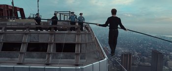 Movie still from “The Walk” (2015), directed by Robert Zemeckis – A group of people standing on top of a building; Wide shot, Over the shoulder angle