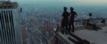 Movie still from “The Walk” (2015), directed by Robert Zemeckis – A couple of men standing on top of a tall building; Extreme Wide shot, High angle