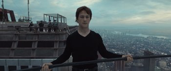 Movie still from “The Walk” (2015), directed by Robert Zemeckis – A man standing on top of a tall building; Medium shot, Low angle