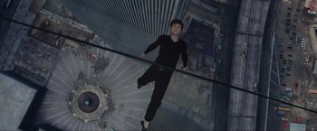 Movie still from “The Walk” (2015), directed by Robert Zemeckis – A man standing on the edge of a glass wall; Wide shot, Overhead angle