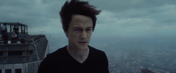 Movie still from “The Walk” (2015), directed by Robert Zemeckis – A man with a black shirt is looking at the sky; Close Up shot, High angle