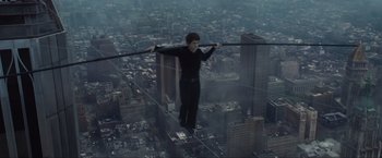 Movie still from “The Walk” (2015), directed by Robert Zemeckis – A man standing on the edge of a tall skyscraper; Wide shot, High angle