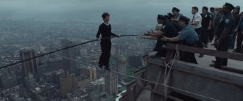 Movie still from “The Walk” (2015), directed by Robert Zemeckis – A group of people standing on top of a tall building; Wide shot, High angle