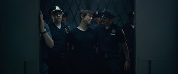 Movie still from “The Walk” (2015), directed by Robert Zemeckis – A group of police officers standing next to a woman; Medium shot, Over the shoulder angle