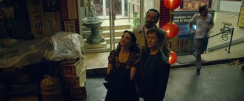 Movie still from “The Walk” (2015), directed by Robert Zemeckis – A group of people standing next to each other in front of a building; Medium shot, High angle