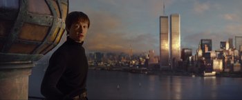 Movie still from “The Walk” (2015), directed by Robert Zemeckis – A man standing in front of a city skyline; Medium shot, Low angle